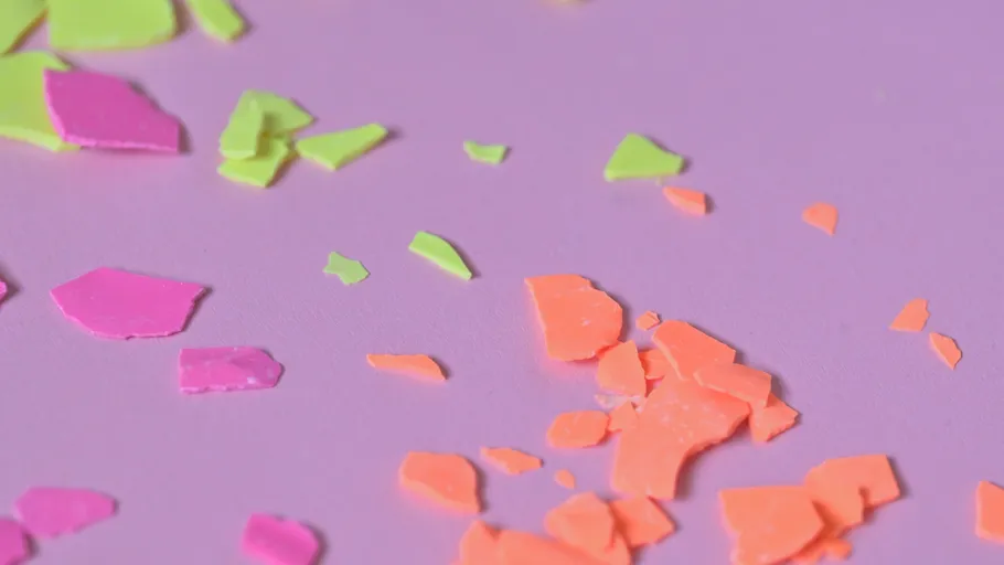 Colorful, broken pieces scattered on purple background.