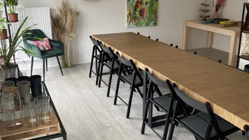 Long table with chairs in a bright room.