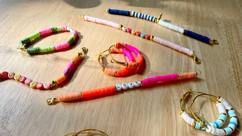 Colorful bracelets with letter beads on table.