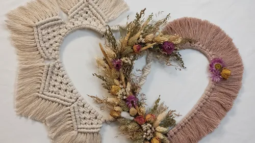 Heart-shaped macrame and dried flower wall decorations.