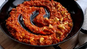 Red sauce with nuts, arranged in a spiral pan.