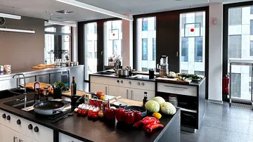 Modern cuisine with fresh ingredients on the work surfaces.
