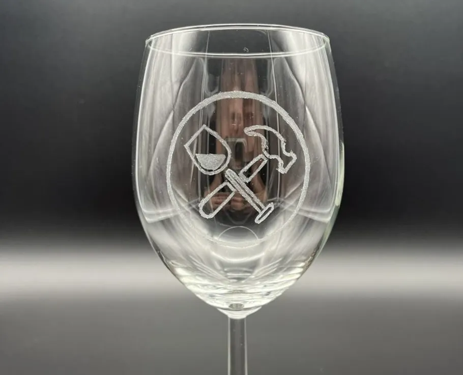 A wine glass shows an engraved tool design.