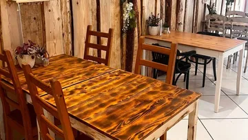 Wooden table with chairs in a cozy room.
