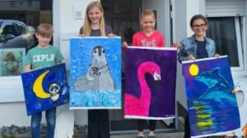 Four children hold colorful pictures in a front door.