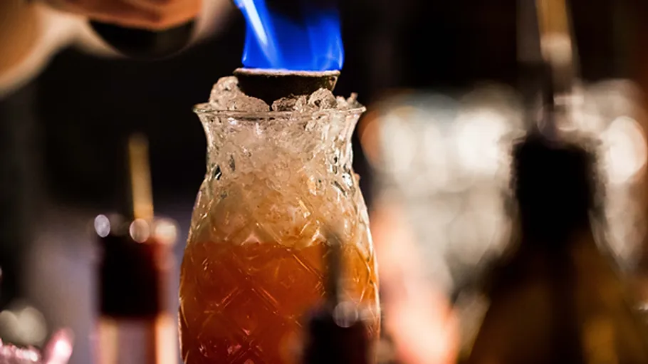 bottle with ice, burning contents, bar-like environment.