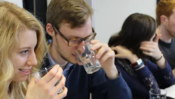 Young adults drink water in good company.