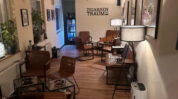 Cosy room with armchairs, tables and cigar bar.