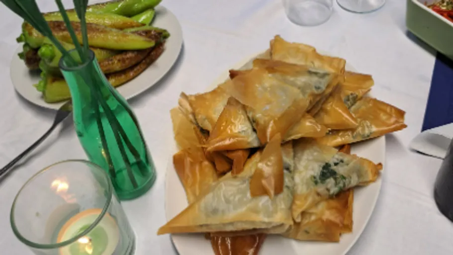 Pasta is laid out on a plate surrounded by side dishes.