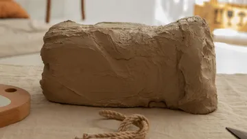 A lump of clay is lying on a table.