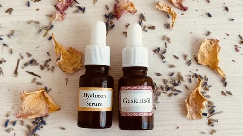 Two bottles of care products lie on a wooden surface.