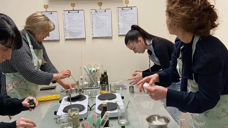 Women cook together in a bright kitchen.