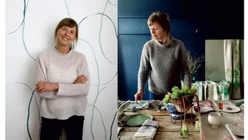 Woman smiles and arranges decoration on a table.