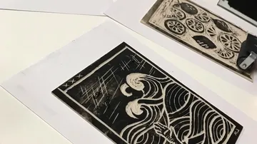 Two prints on paper show artistic wave patterns.