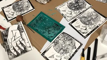Printing plates are scattered on a work table.