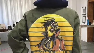 Green jacket with yellow artistic “Toxic World” design