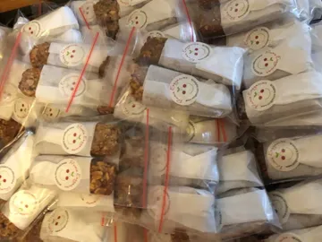 Packages of snacks are packed in bags and stacked.