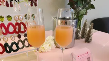 Two glasses of frothy drink on a festive table.
