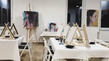 Canvases are available in an artistic space.