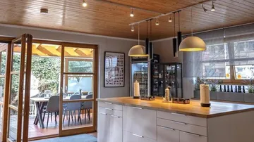Modern kitchen with open doors to the garden area.