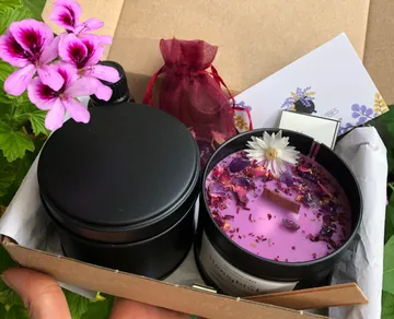 Box with candles, flowers and a small pouch.