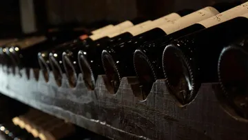 Bottles are neatly stored on a shelf-like wooden board.