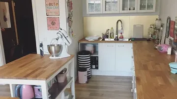 Modern kitchen with work surface and stand mixer.