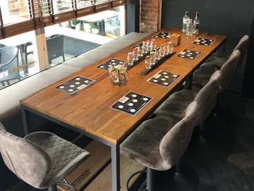 A wooden tray with glasses and snacks on a table.