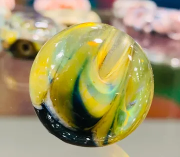 Colourful marble is shining on a table.