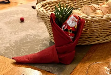 Red cloth holds chocolate figure, decorated for festive food