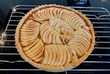 Apple cake on a shelf, caramelized, freshly baked.