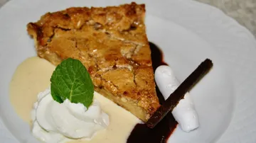 A piece of cake lies on a plate with garnish.