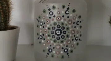 A decorative glass bottle shows a colorful pattern.