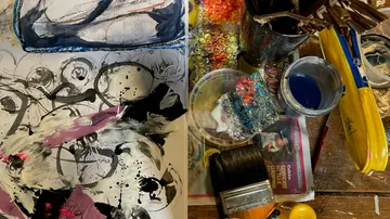 Paints and tools on an artist's workplace, painting in progress.