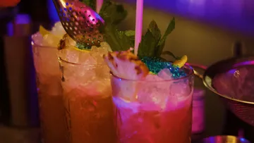 Cocktails with ice cream are decorated in a bar.
