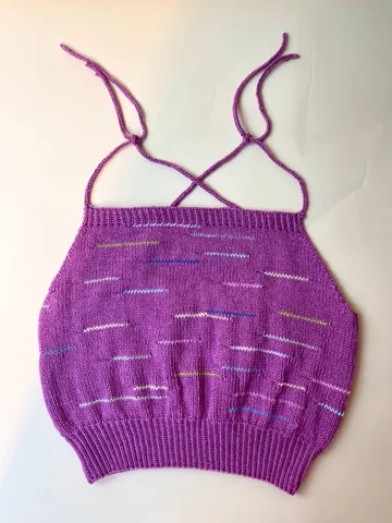 Purple top with thin straps on white background.
