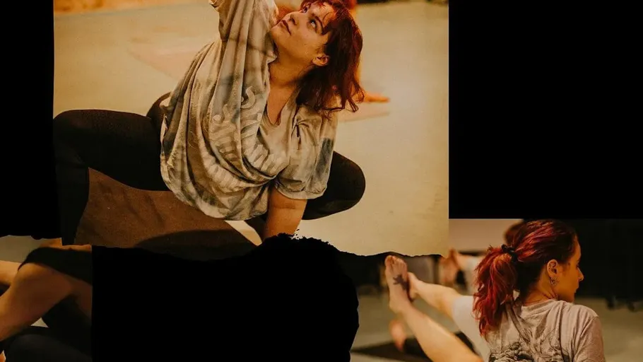 A dancer stretches in a creative practice room.