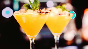 Two cocktails in glasses with ice and mint.