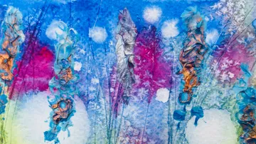 Colourful abstract flowers stand against a blue background.