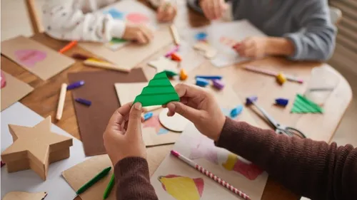 Handicraft materials are used creatively on a table.