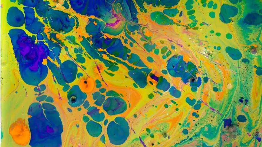 Colourful blobs and patterns of paint spread across the surface.