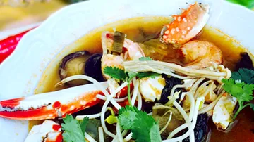 Bowl of seafood in spicy broth.