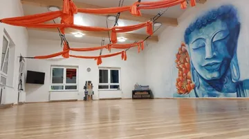 Empty room with red cloths and Buddha paintings on the wall.