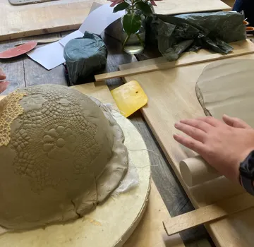 Clay ball is machined to create ceramic shapes.