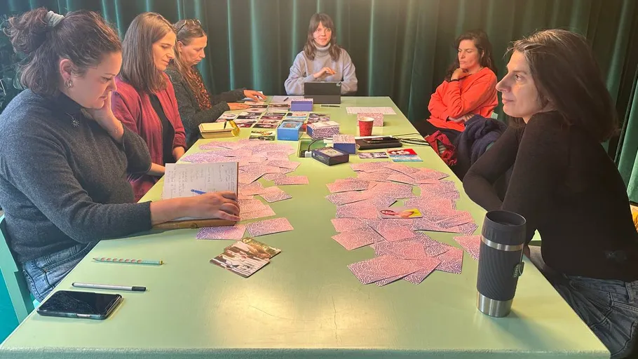 Women sitting around a table with cards.