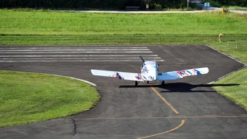 An airplane rolls on a runway.