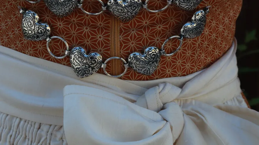 Heart-patterned corset with white bow belt.