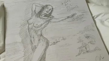 Nude drawing of a woman stretching out on a beach.