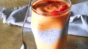A glass decorated with chia pudding and creamy topping.