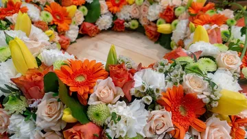 Colourful flower arrangement is on a table.